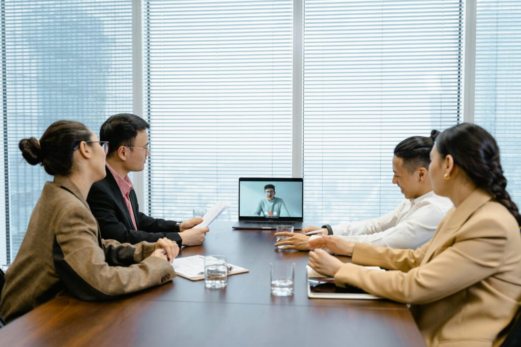 Startseite Business meeting with video call setup, highlighting teamwork and communication in a modern office environment.