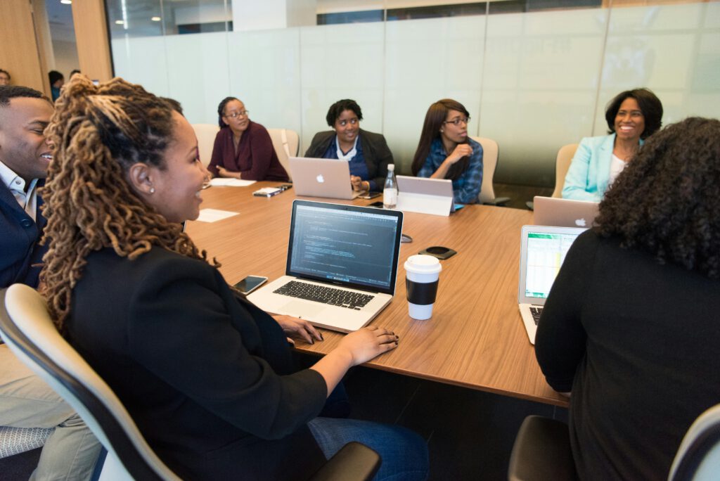 pexels photo 1181370 1181370 A diverse group of professionals working together in a modern conference room with laptops.
